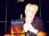 Photo of John Mayall with poster by Bob Masse